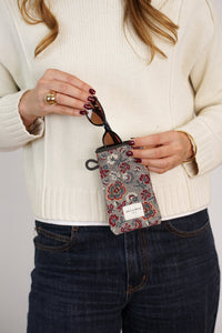 Model slipping sunglasses into DE LA MUR Floral Jacquard Glasses Case