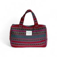 DE LA MUR Aura striped jacquard XL makeup bag in pink and burgundy, front view