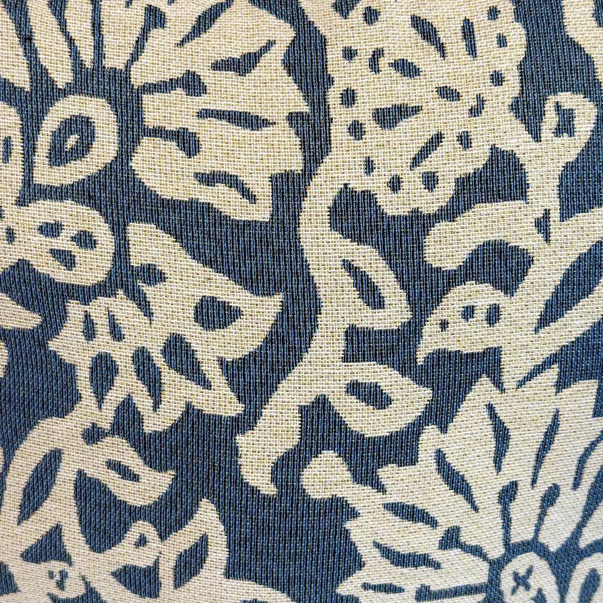 Close-up of the off-white and blue floral jacquard fabric of the DE LA MUR Akay bag