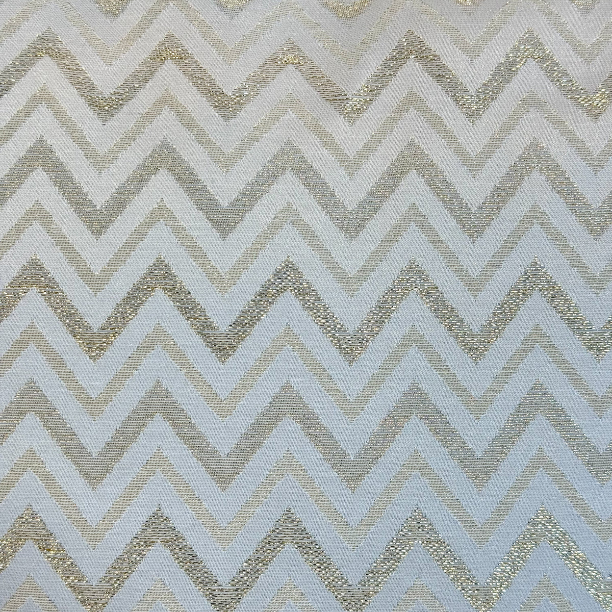 Close-up of the DE LA MUR metallic gold zigzag chevron fabric