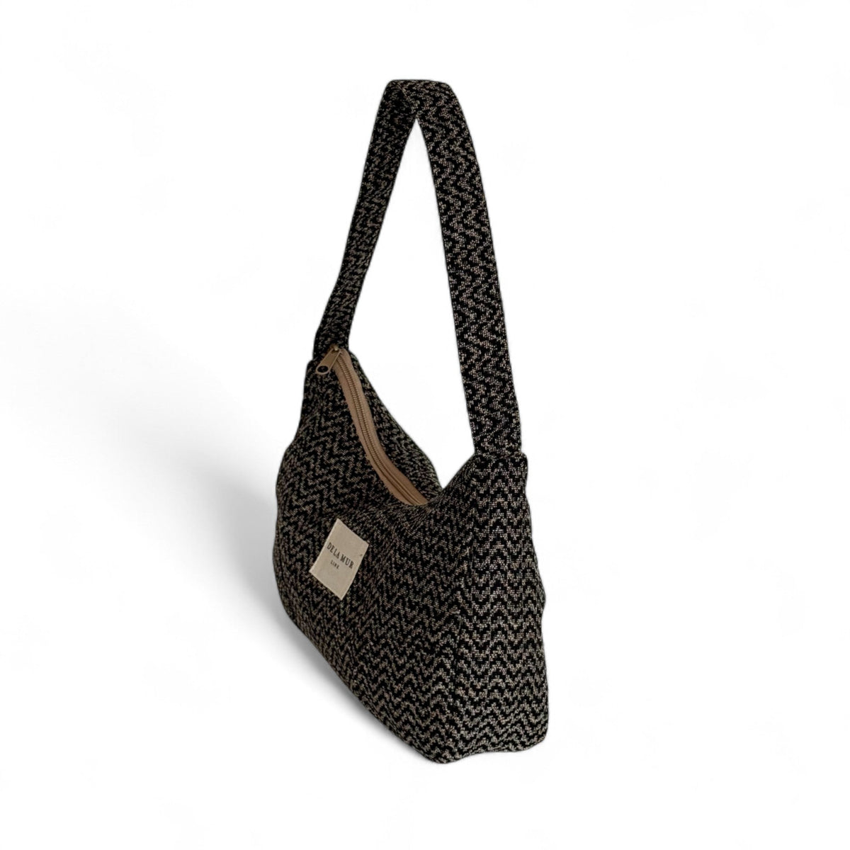 Three-quarter view of the DE LA MUR Dana zigzag jacquard shoulder bag