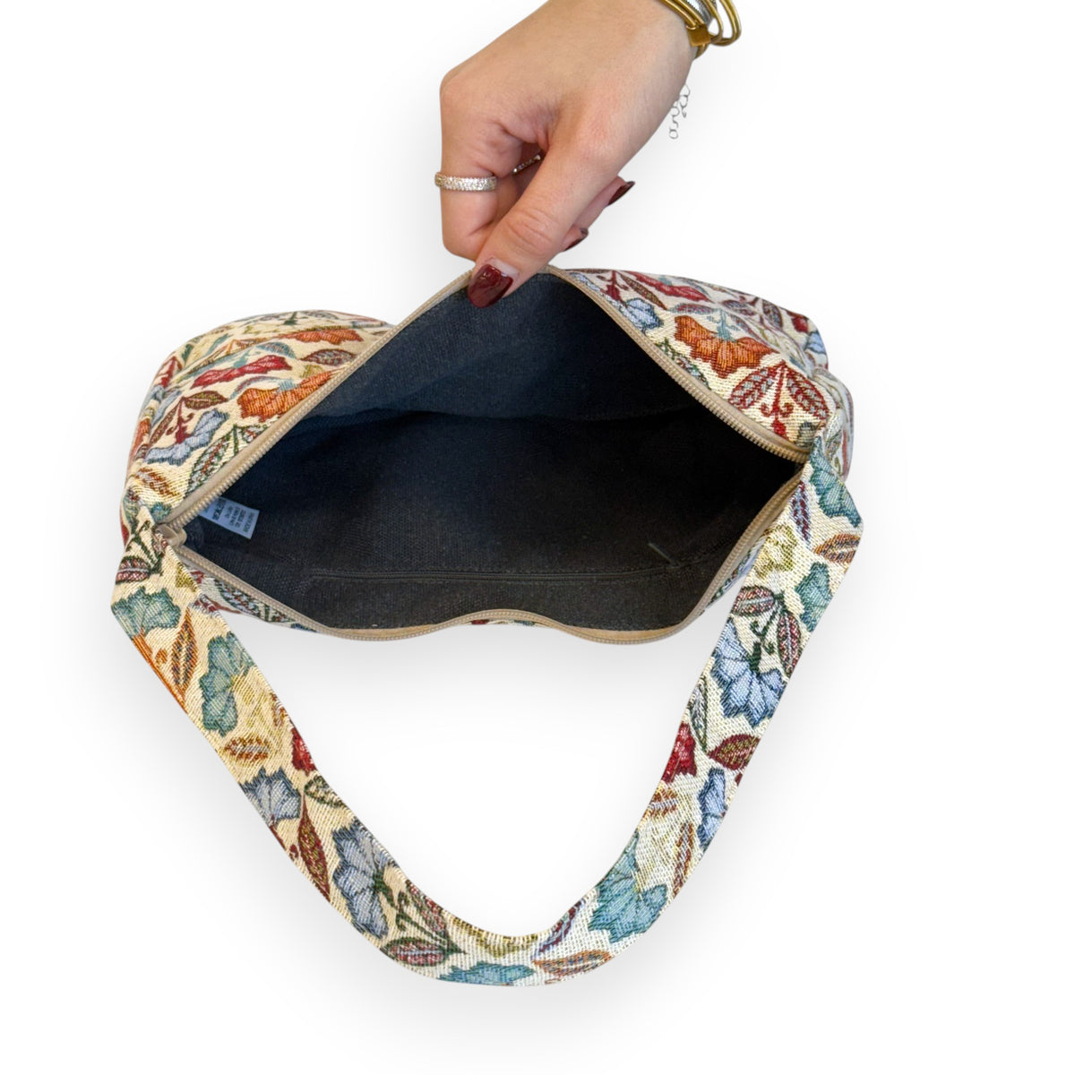 Open DE LA MUR Flora shoulder bag showing the dark lined interior with zip pocket