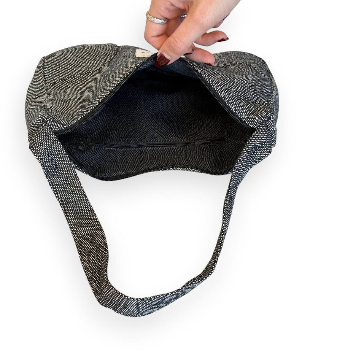 Open DE LA MUR Sinay shoulder bag showing the black lined interior and zip pocket