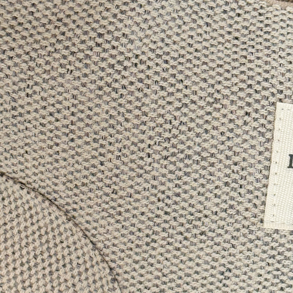 Close-up of the DE LA MUR Sydney beige and gray woven fabric texture