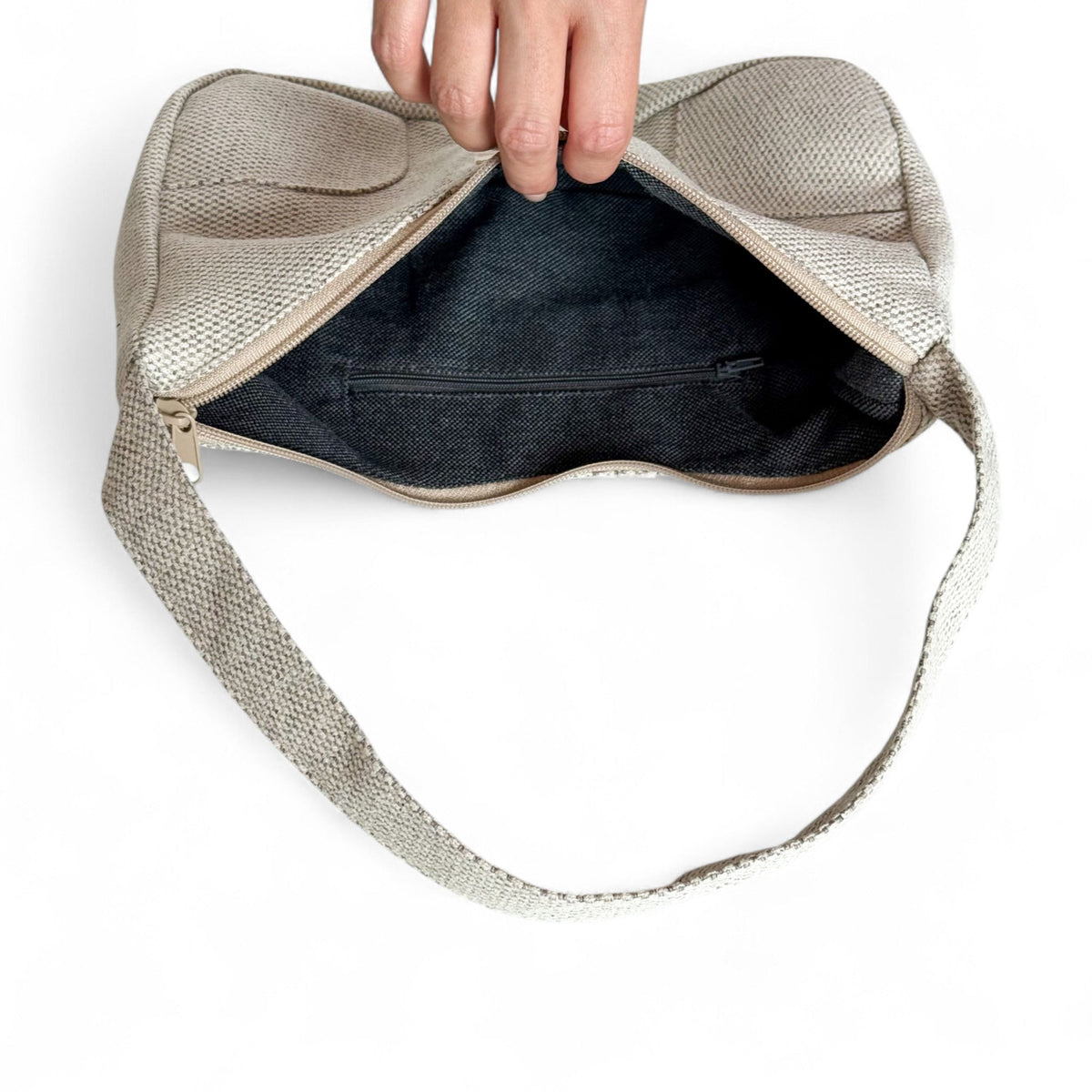 Open DE LA MUR Sydney shoulder bag showing dark lined interior with zip pocket