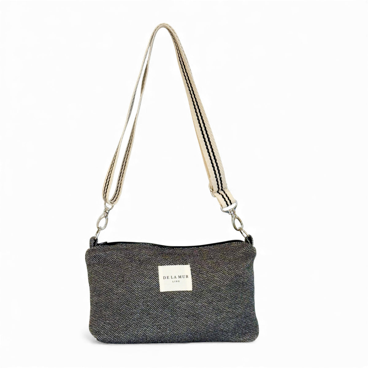 DE LA MUR Sinay striped jacquard clutch handbag in dark gray, front view with crossbody strap