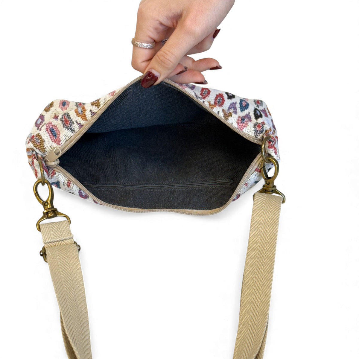 Open DE LA MUR Urban clutch bag showing dark lined interior and pocket