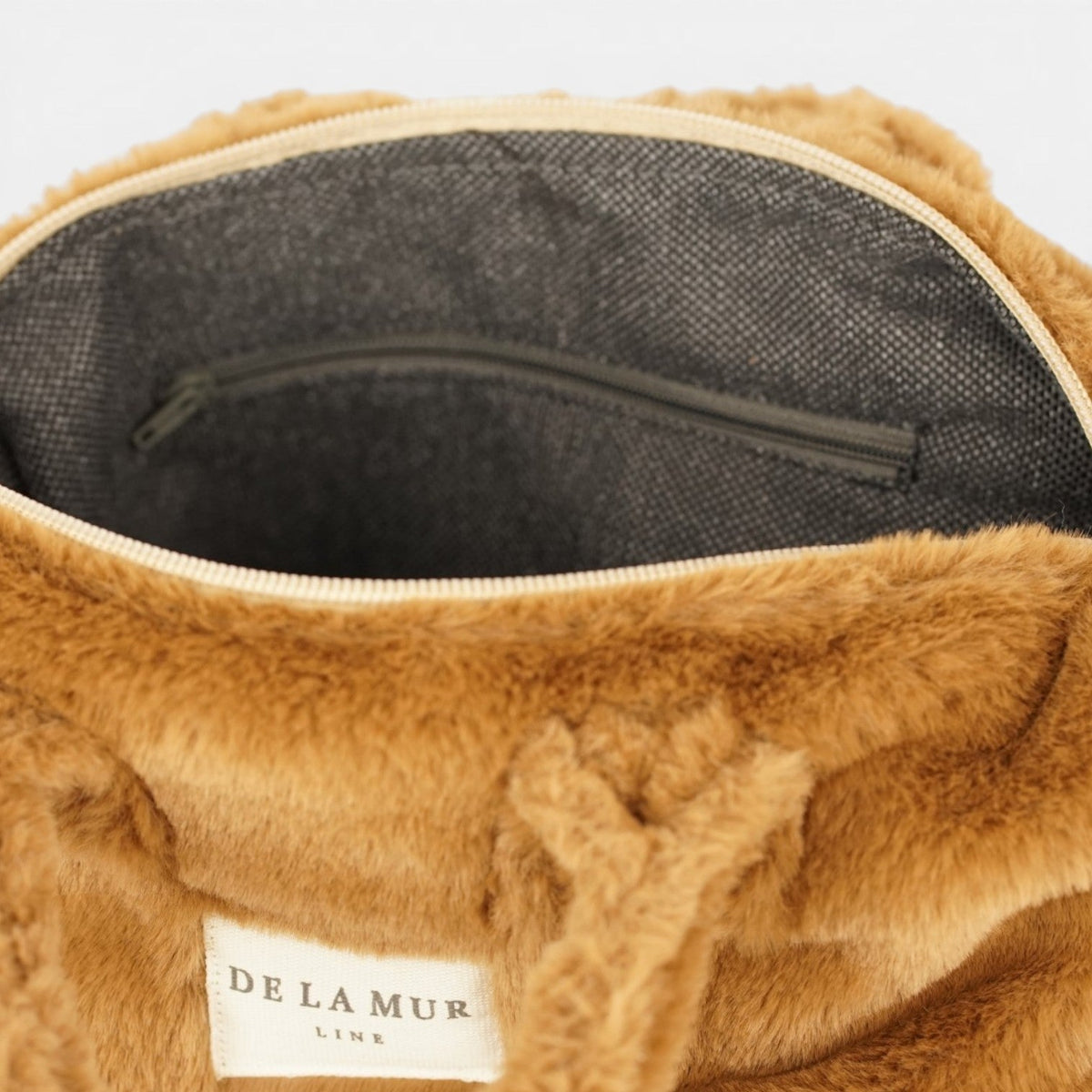 Open DE LA MUR camel brown faux fur small handbag showing the lined interior and zip pocket