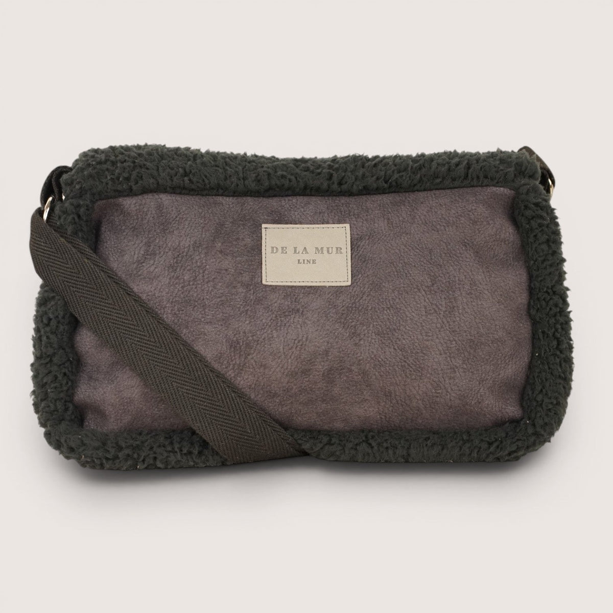 DE LA MUR Cene faux suede small shoulder bag in black, front view on plain background