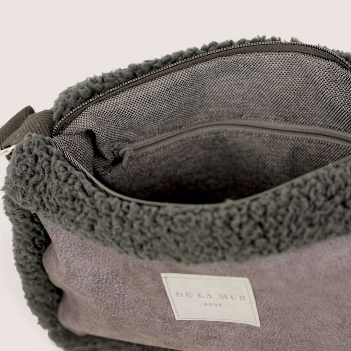 Open DE LA MUR Cene small shoulder bag showing the lined interior with zip pocket