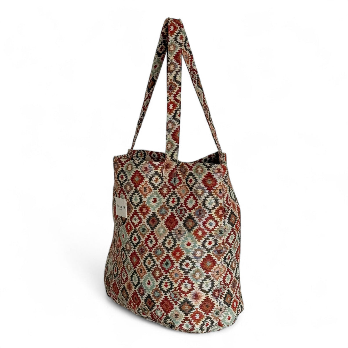 Side three-quarter view of the DE LA MUR Bea geometric jacquard tote bag