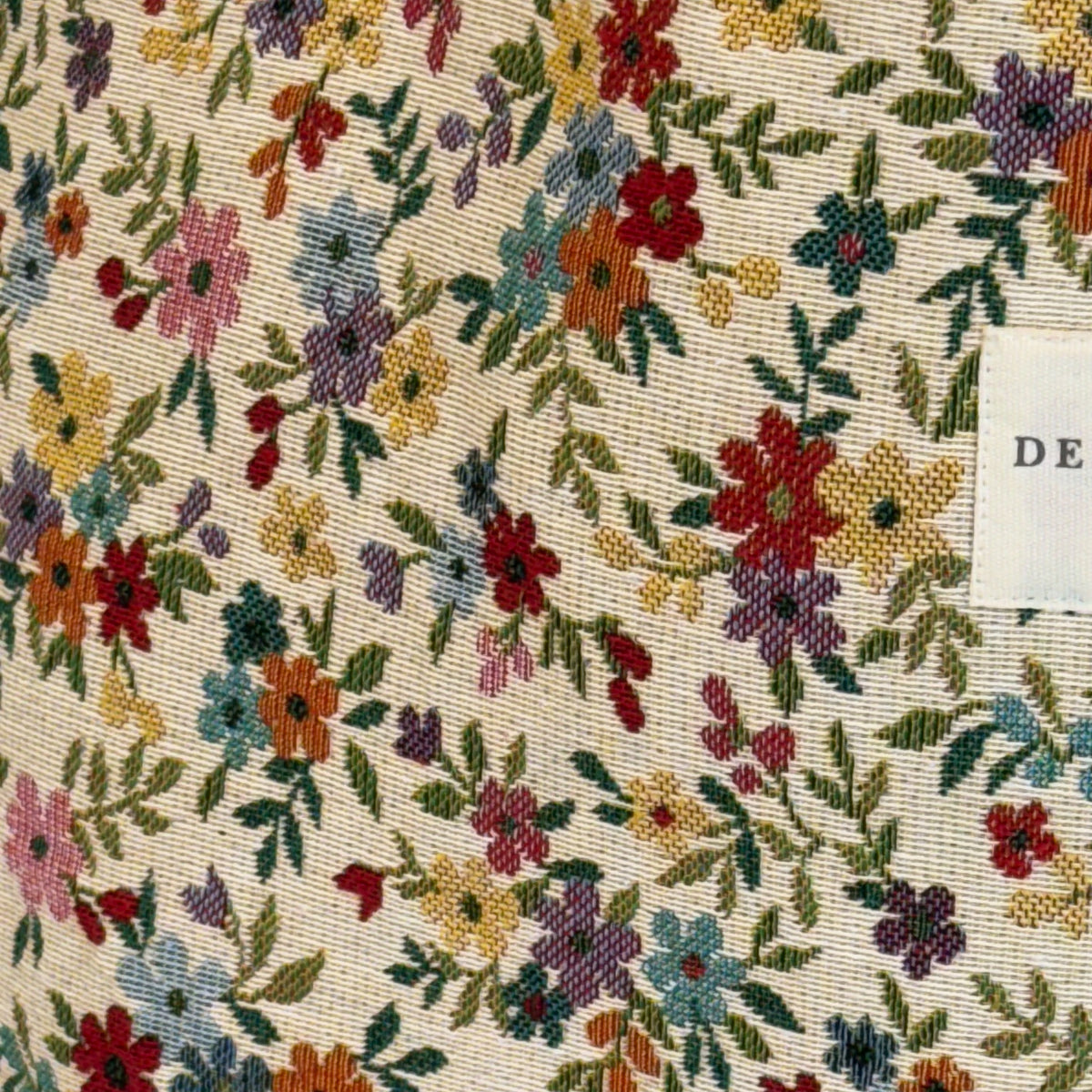 Close-up of the multicolor floral jacquard fabric of the DE LA MUR Blum bag