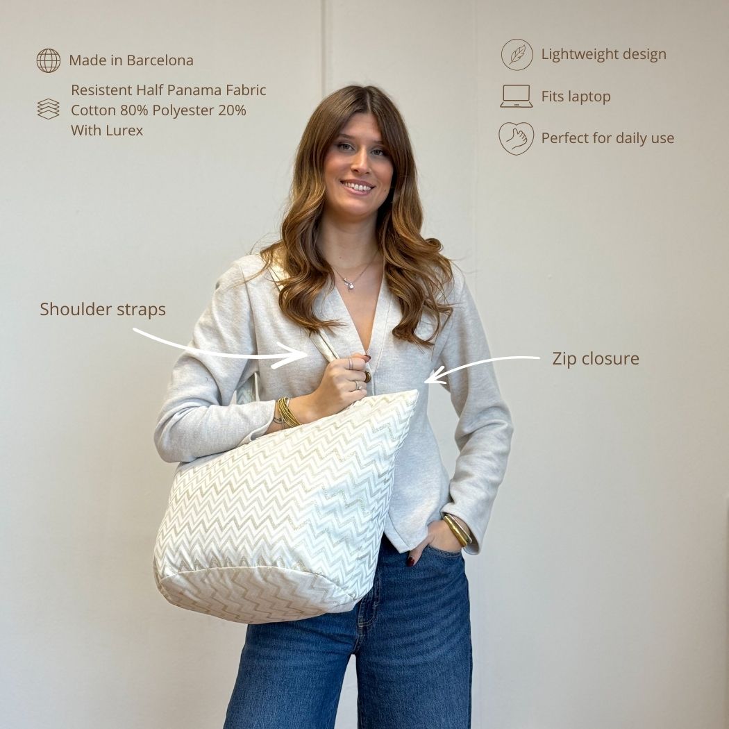Model carrying the DE LA MUR Astro zigzag tote bag, features infographic