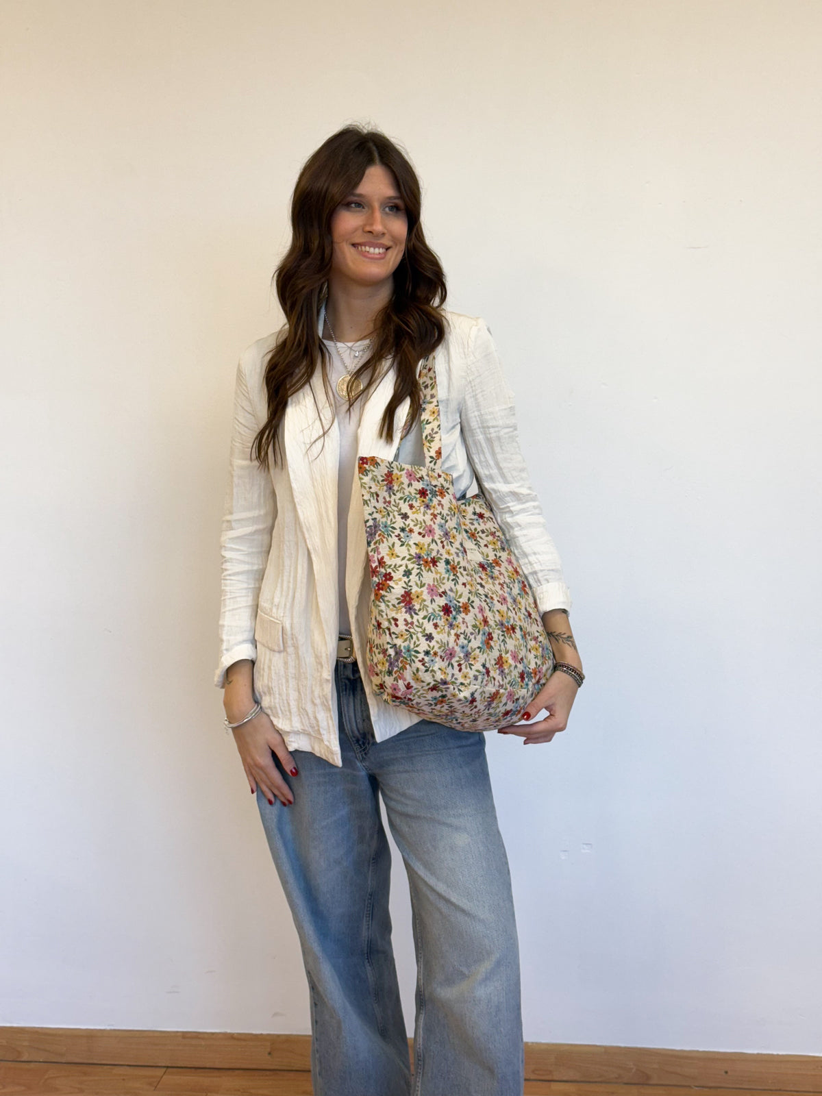 Model carrying the DE LA MUR floral jacquard Blum tote bag in a styled outfit
