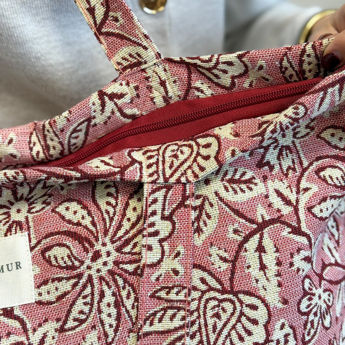 Open DE LA MUR Came floral tote showing the interior zip