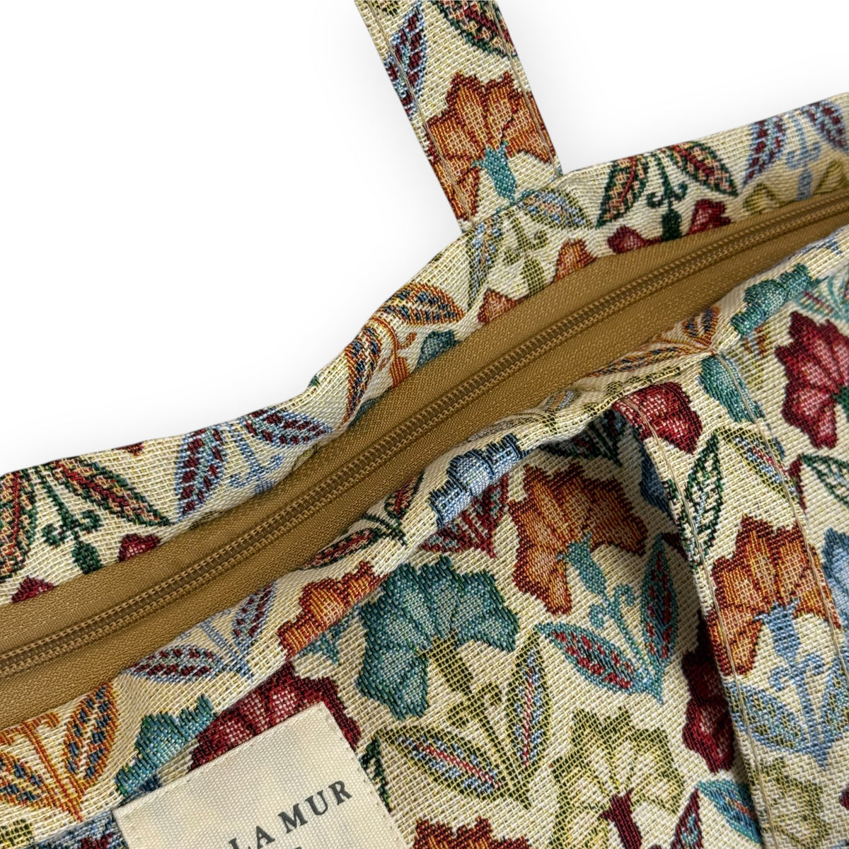 Open DE LA MUR Flora tote showing the zip closure and Line label
