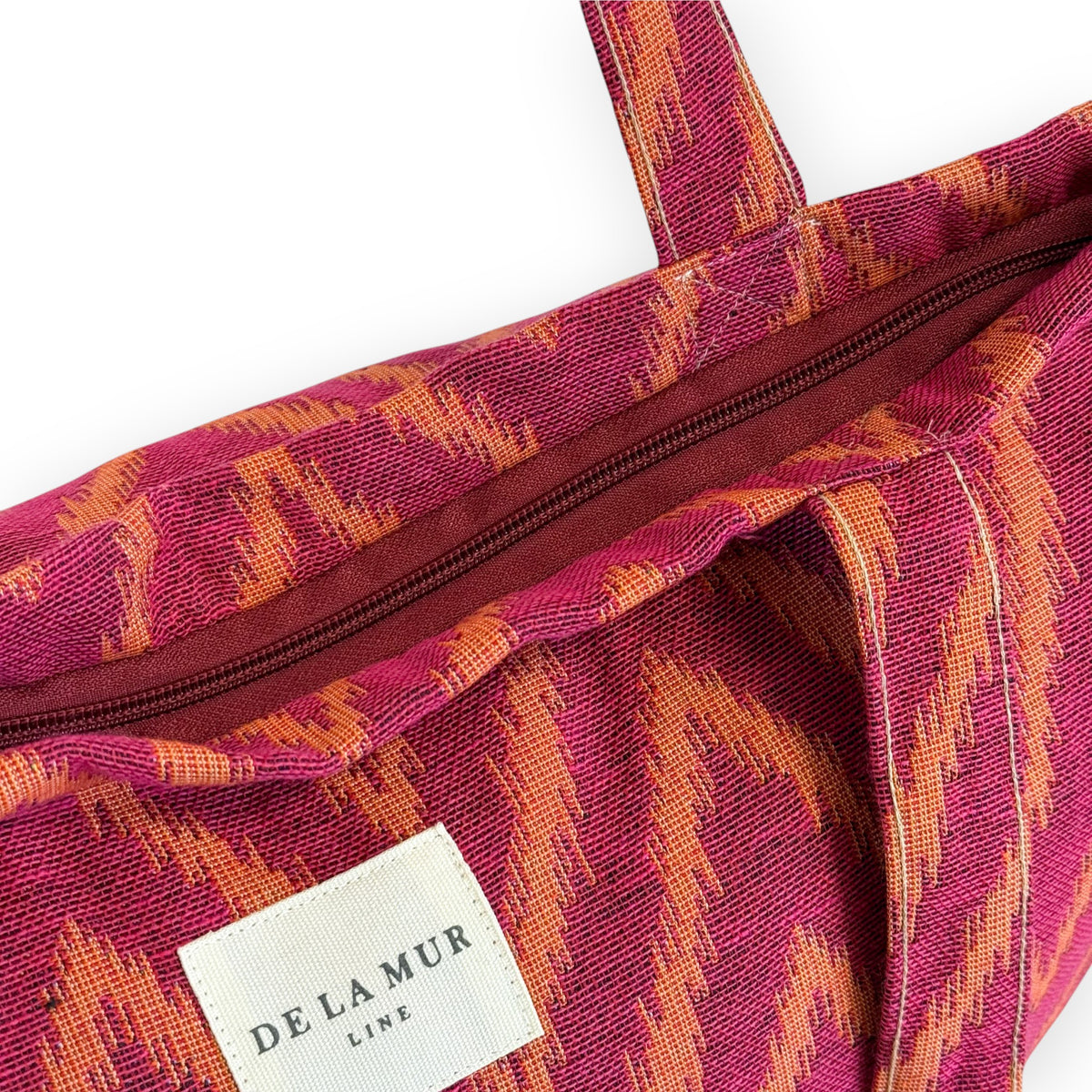Open DE LA MUR Fuego tote showing the zip closure and Line label