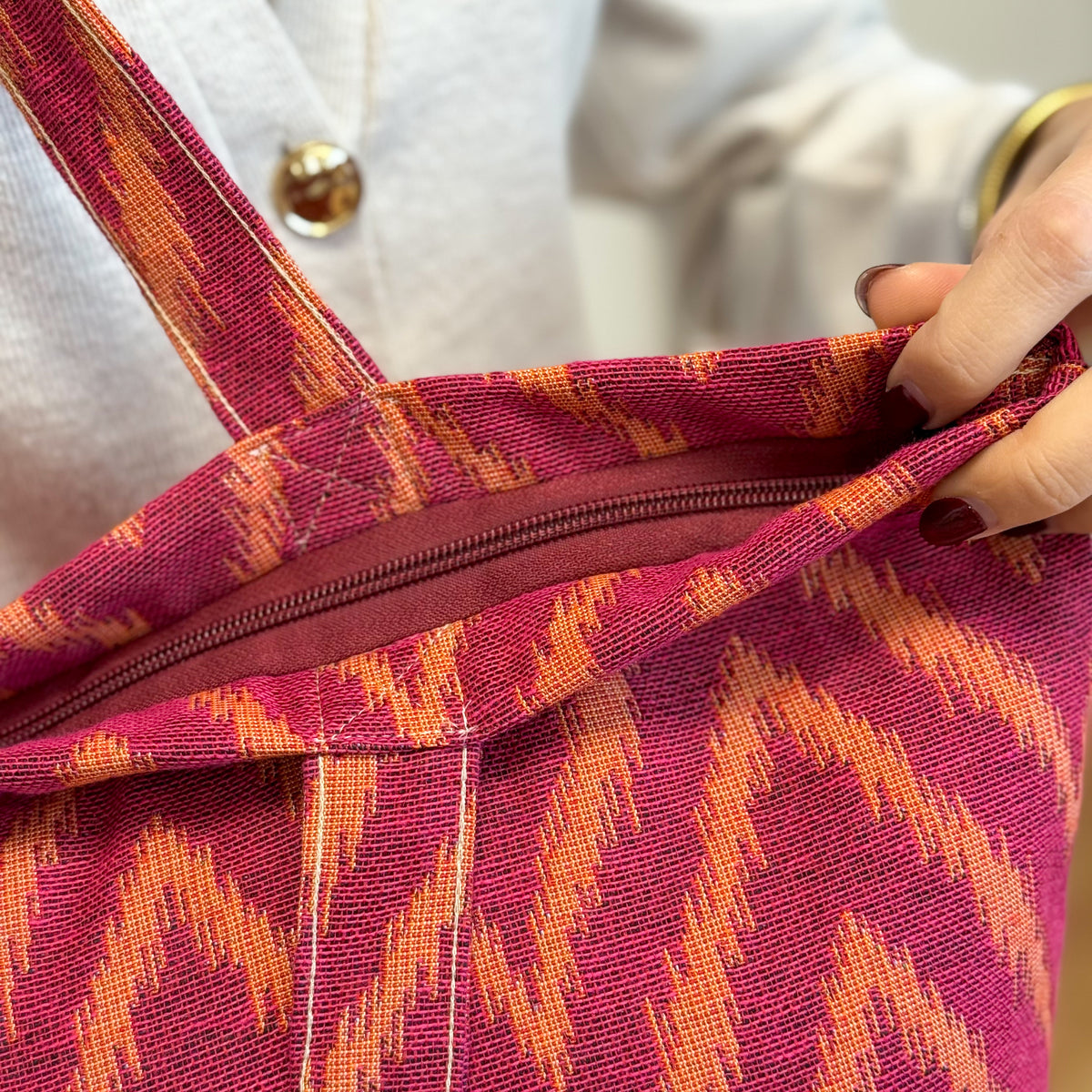 Close-up of the DE LA MUR Fuego tote interior zip and straps
