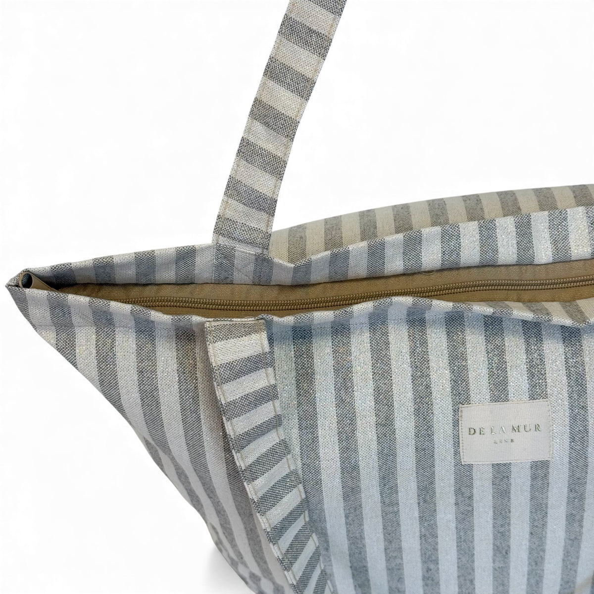 Open DE LA MUR gray striped tote showing the zip closure and interior
