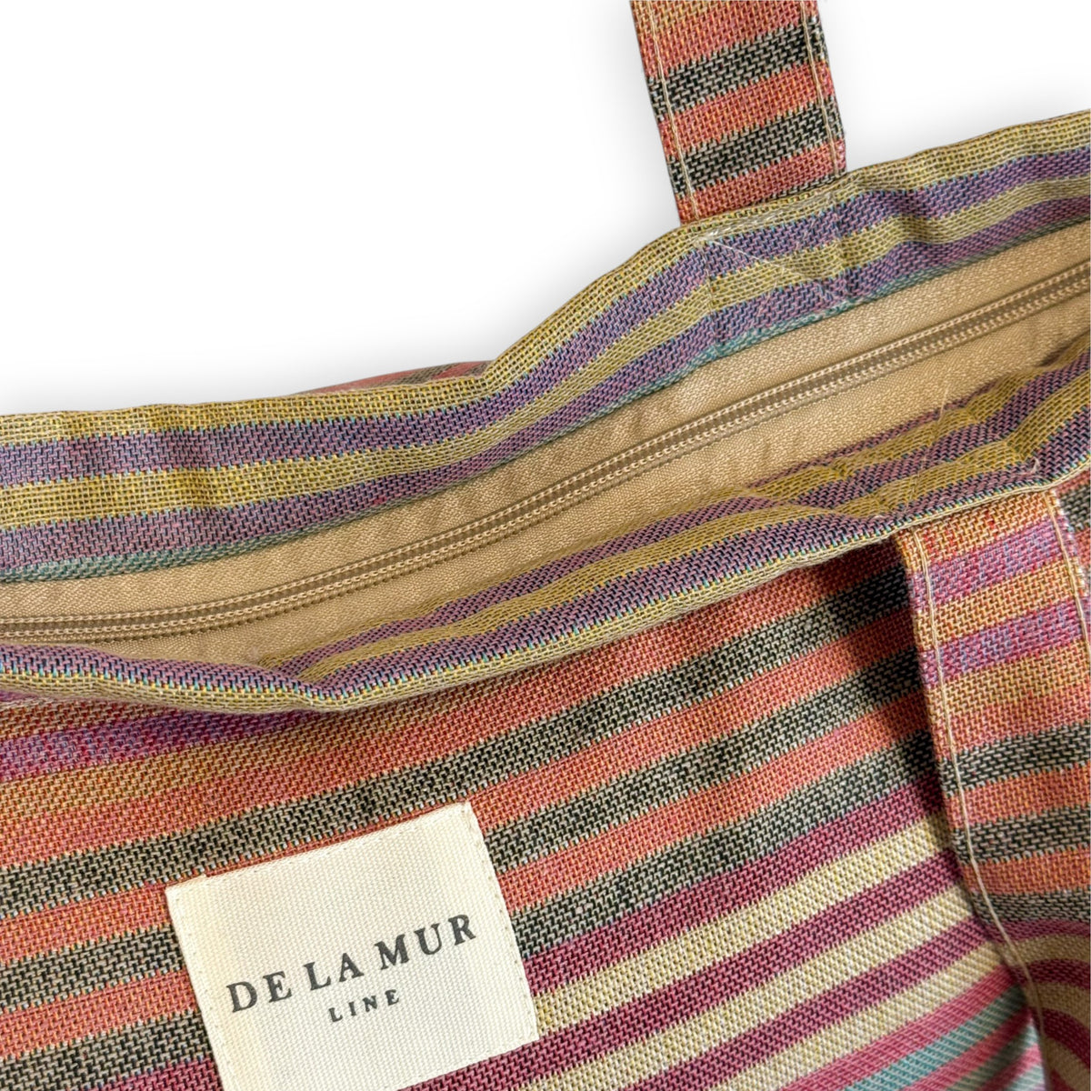 Open DE LA MUR multicolor striped tote showing the zip closure and label