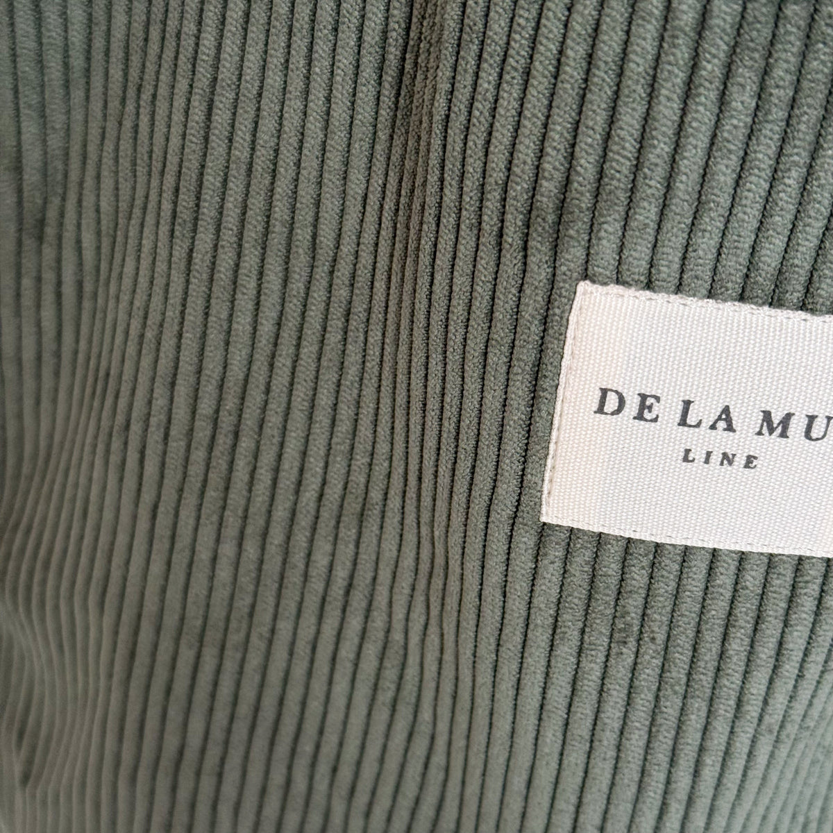 Close-up of the green corduroy fabric and DE LA MUR Line label on the Tree tote