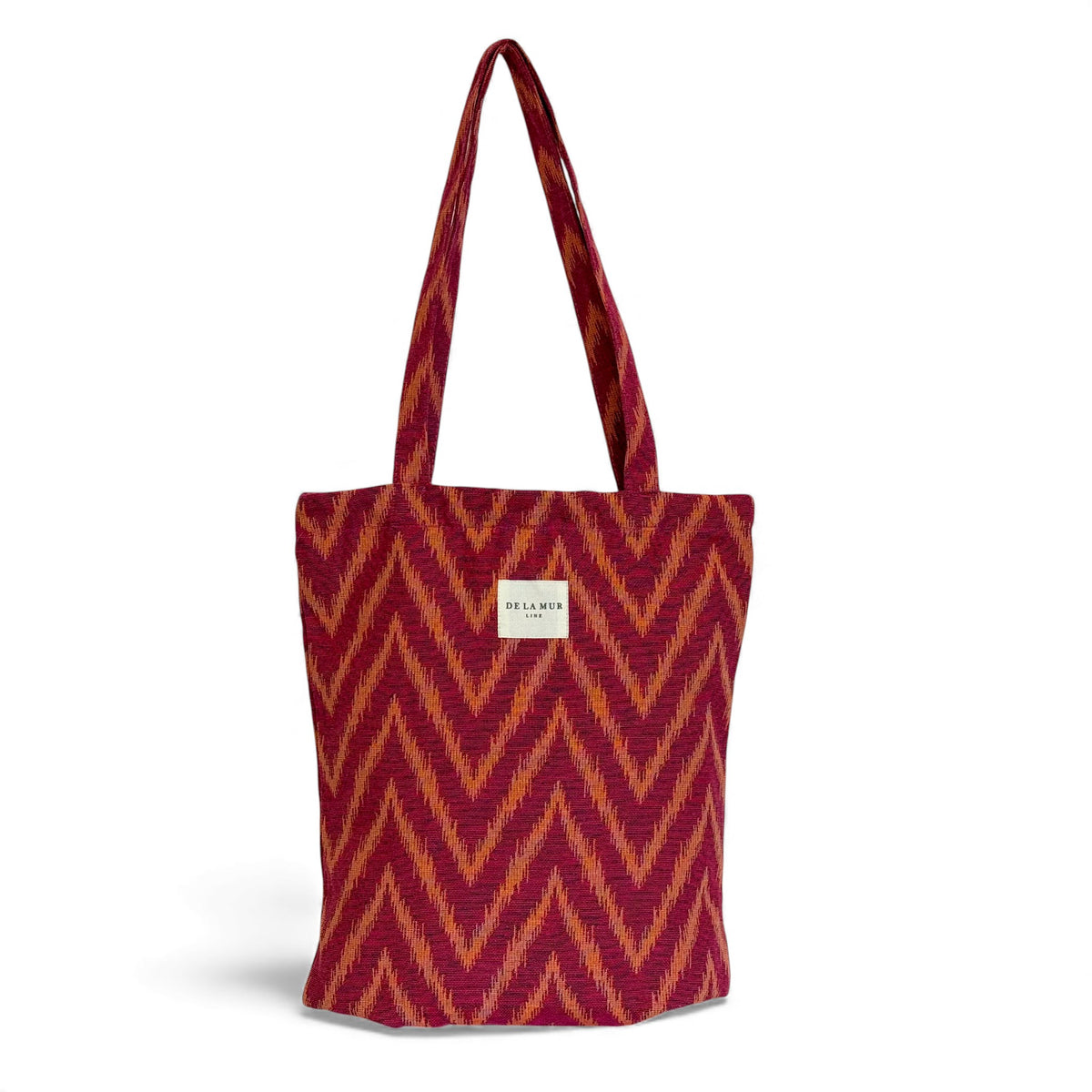 DE LA MUR Fuego zigzag jacquard zippered bag in pink and orange, front view