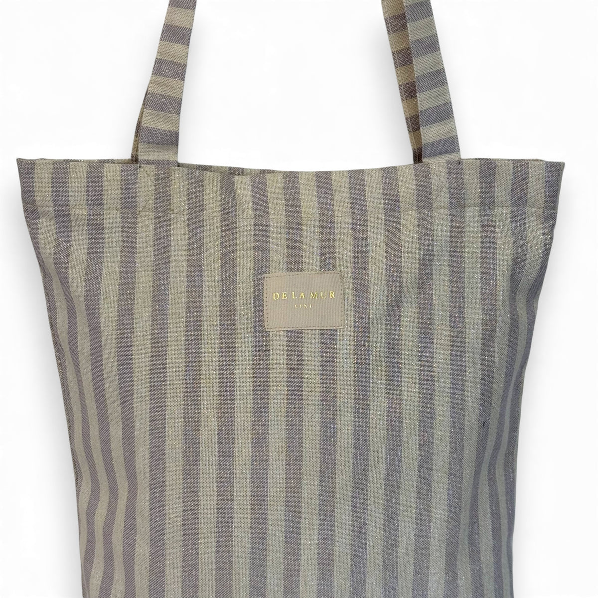Close-up of the DE LA MUR Lulil lilac striped fabric and gold Line label