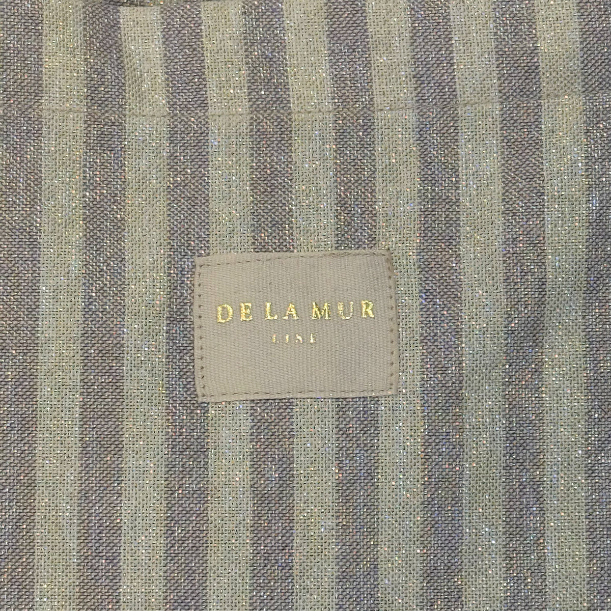 Detail of the lilac striped lurex weave and DE LA MUR Line woven label
