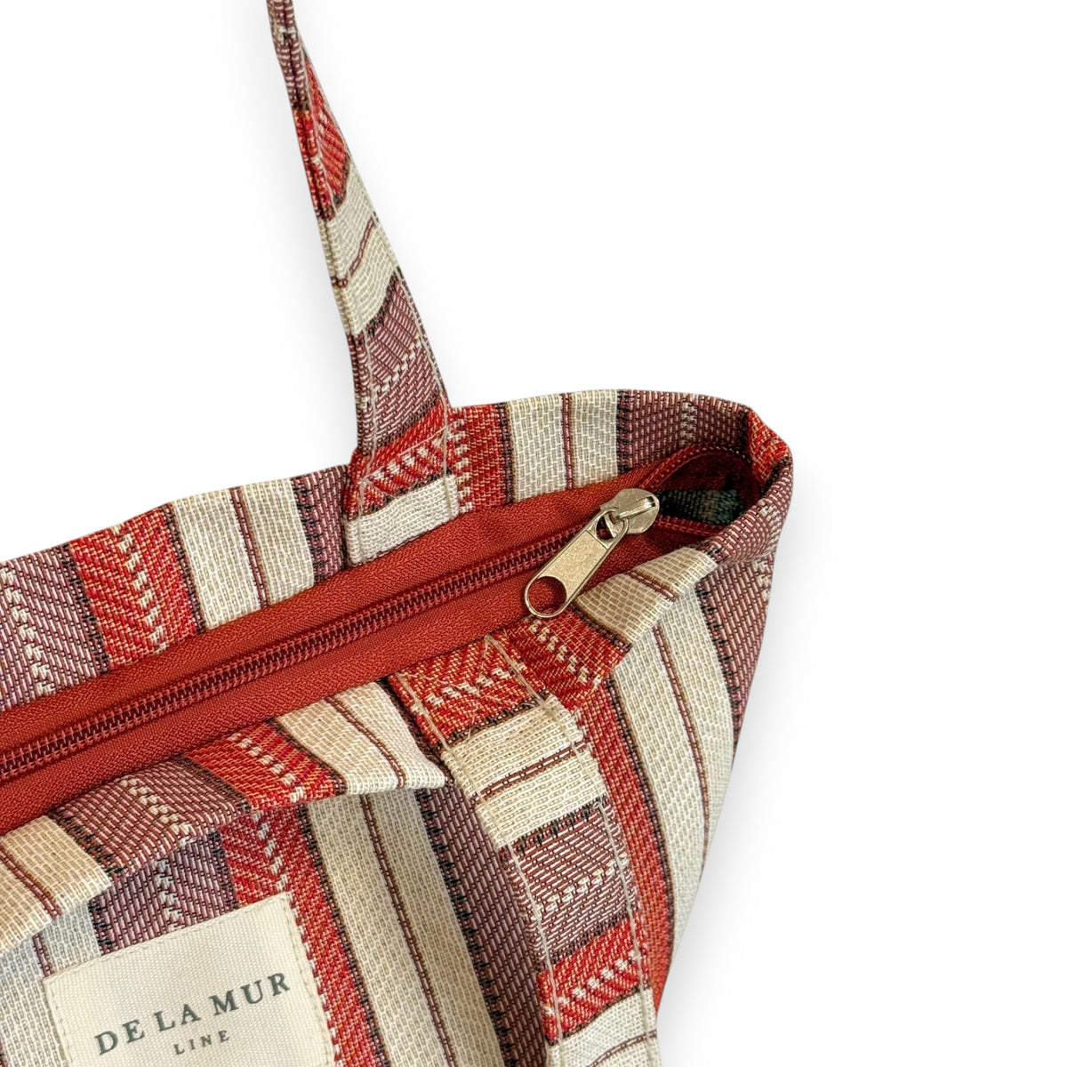 Open DE LA MUR Make bag showing the top zip closure and Line label