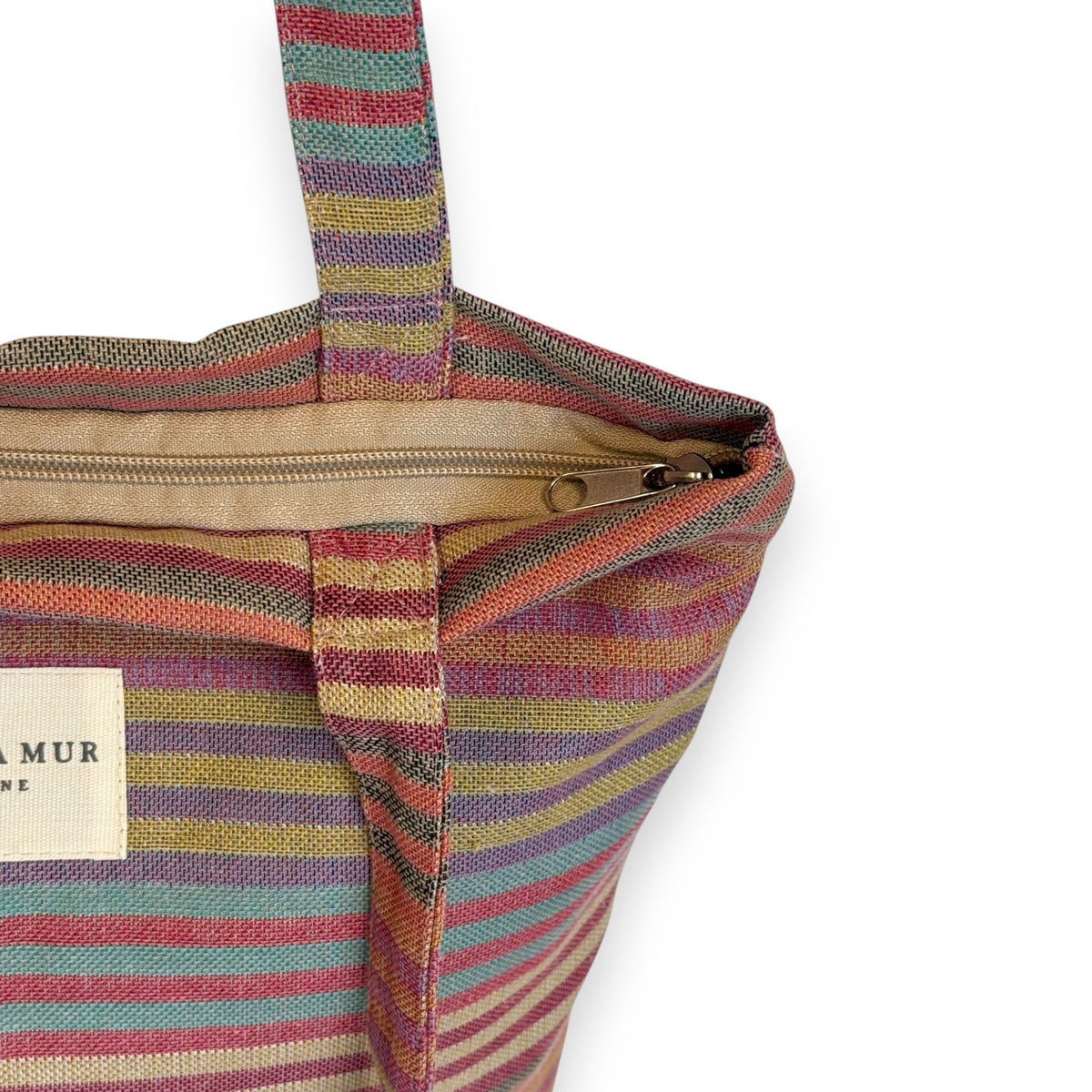 Model carrying the multicolor striped DE LA MUR Maria bag on the shoulder