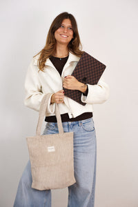 DE LA MUR Corduroy Medium Zippered Bag in cream beige, carried by a model