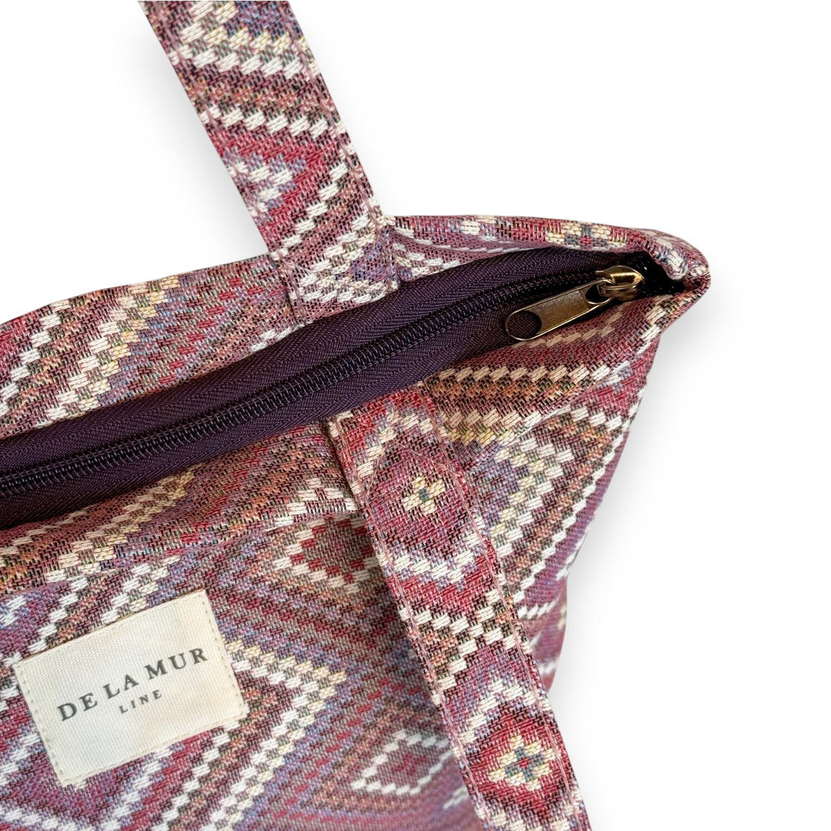Model carrying the pink and lilac DE LA MUR Nana geometric bag on the shoulder