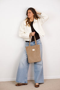 DE LA MUR Toast taupe corduroy bag worn on the shoulder by a model, lifestyle shot