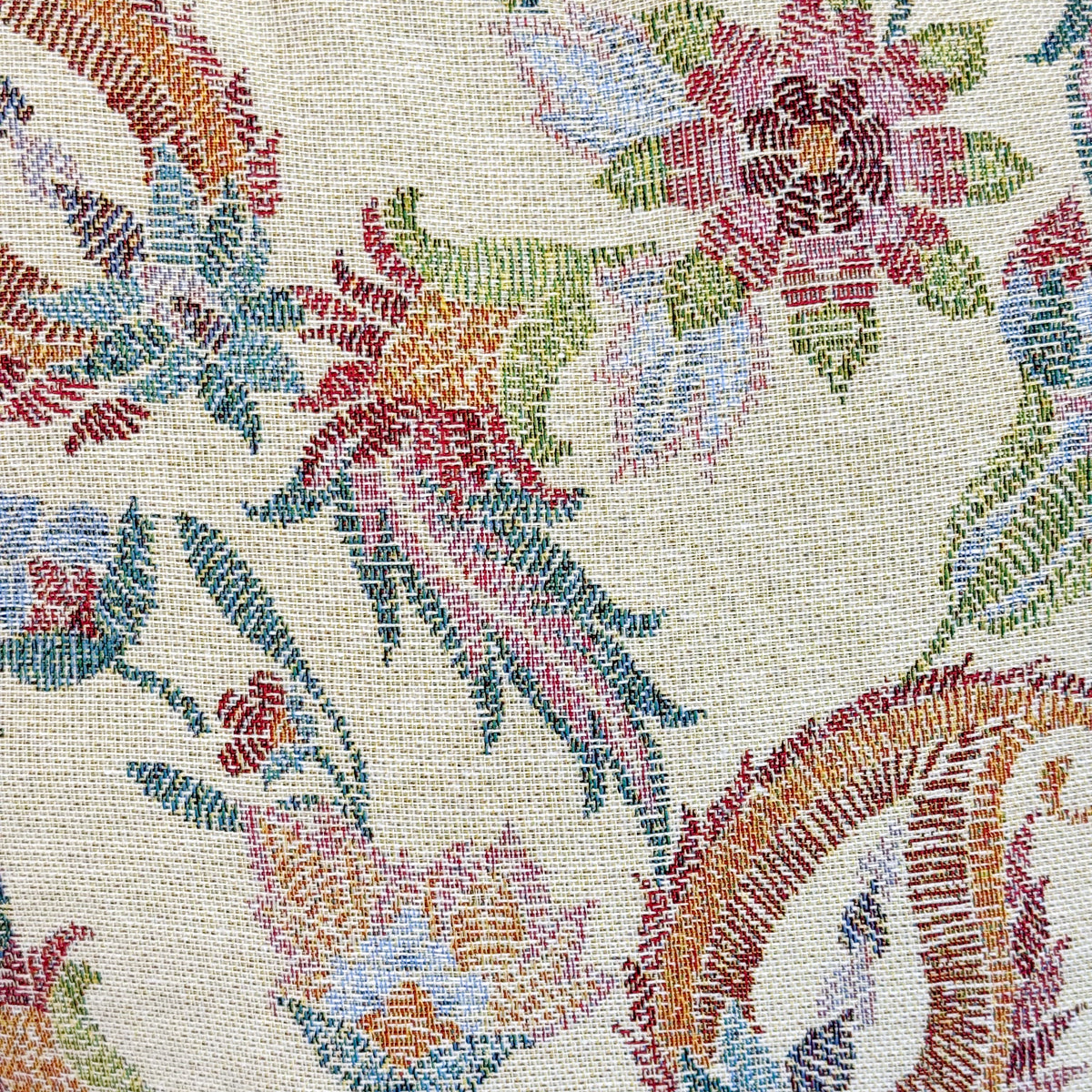 Close-up of the multicolor floral jacquard fabric on the DE LA MUR makeup bag