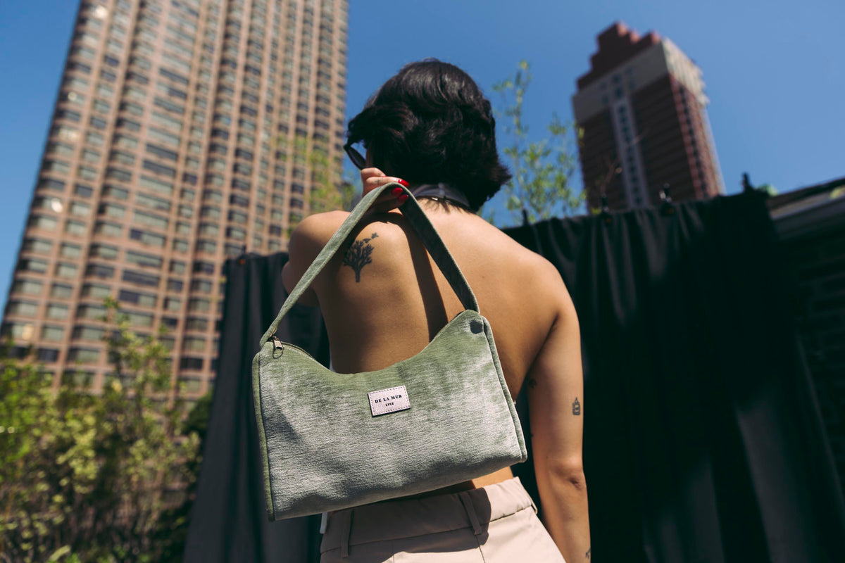 DE LA MUR Menta velvet small evening bag, held in hand, lifestyle shot