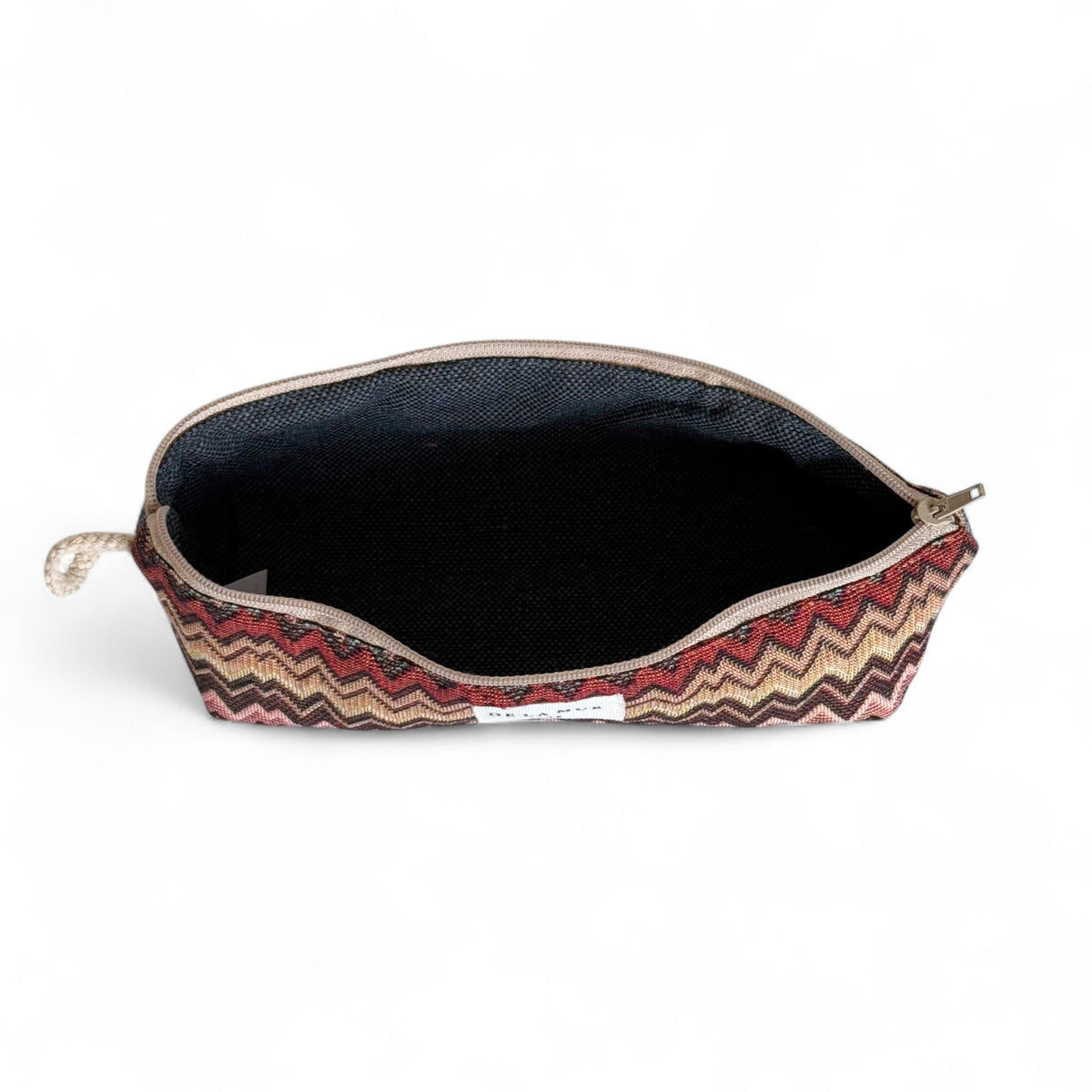 Open DE LA MUR Monte zigzag pencil case showing black lined interior