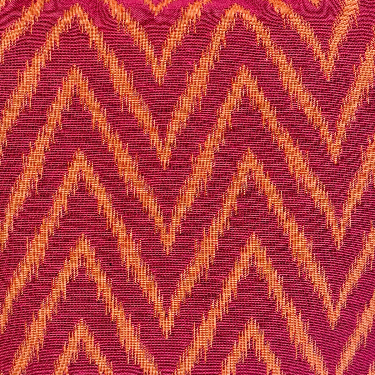Close-up of the pink and orange zigzag jacquard fabric of the DE LA MUR Fuego book cover