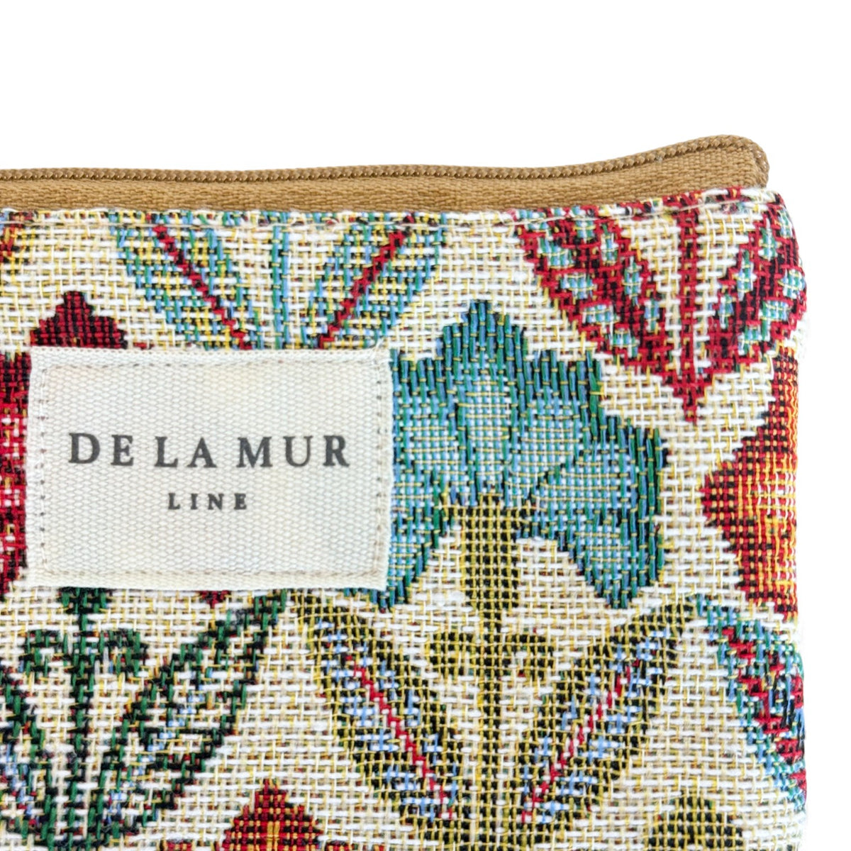 Detail of the DE LA MUR Line label on the Flora floral jacquard eyewear case