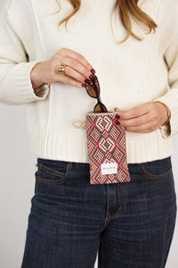 Model slipping sunglasses into DE LA MUR Geometric Jacquard Glasses Case