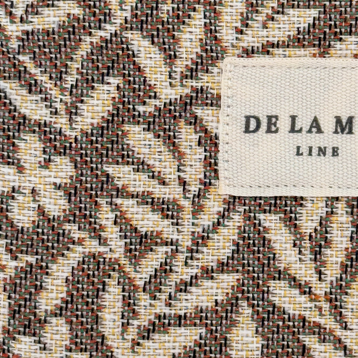Close-up of the woven jacquard fabric and DE LA MUR Line label