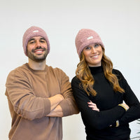 Two models wearing the DE LA MUR Sherpa Beanie in pink, lifestyle shot