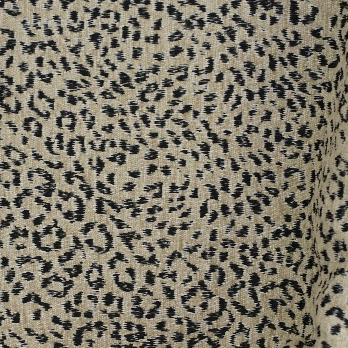 Close-up of the beige and black leopard jacquard weave of the DE LA MUR Koto coin purse