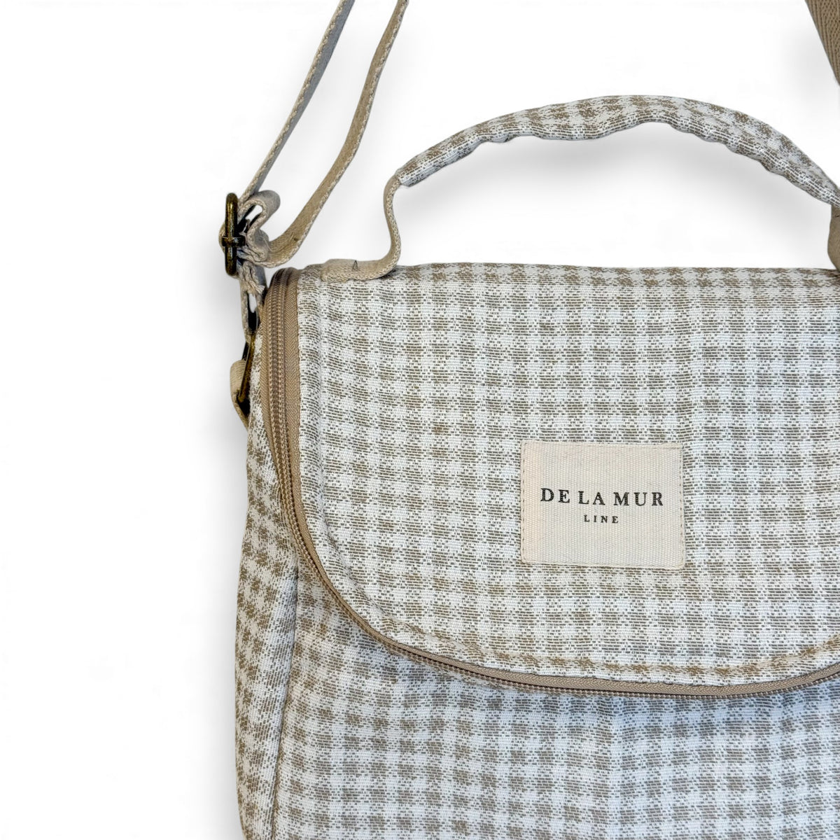 Close-up of the Vison Vichy check fabric and DE LA MUR Line label