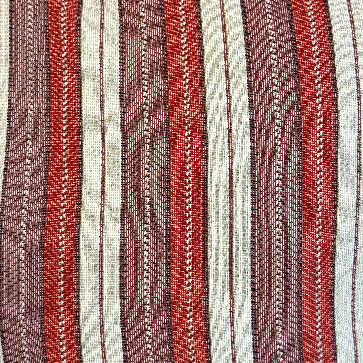 Close-up of the DE LA MUR burgundy, red and cream striped jacquard fabric