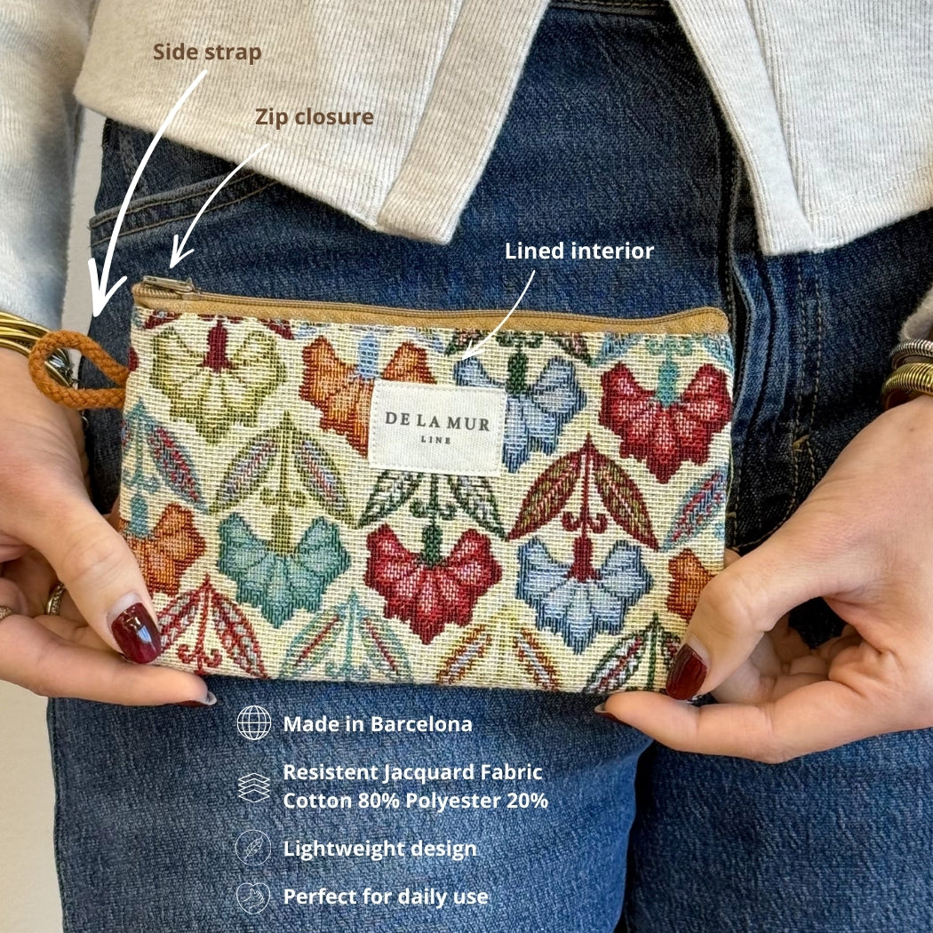Model holding the DE LA MUR Flora floral makeup bag with feature and material callouts