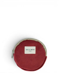 DE LA MUR Bore round coin purse in burgundy with beige trim, front view