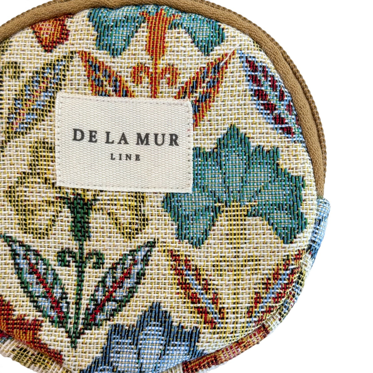 Close-up of DE LA MUR Line label on the Flora floral jacquard coin purse