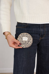 Model holding DE LA MUR leopard jacquard round coin purse at jeans pocket, lifestyle shot