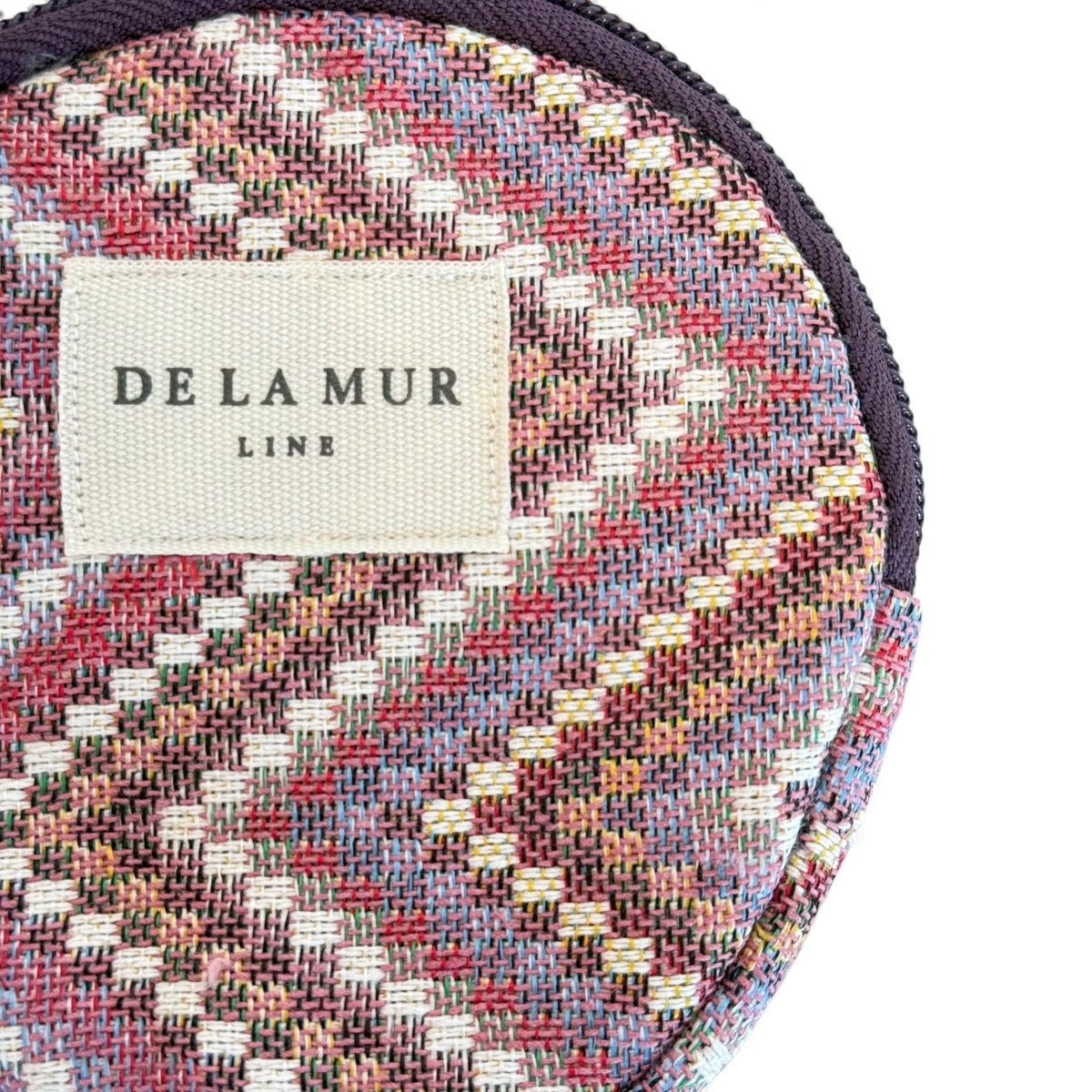 Close-up of DE LA MUR Line label on the Nana geometric jacquard coin purse