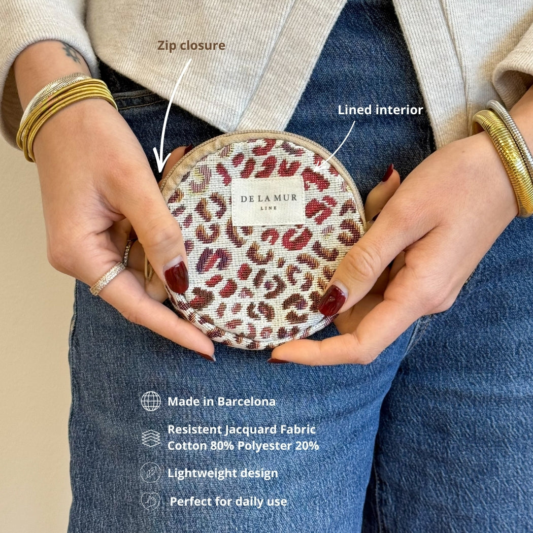 Model holding the DE LA MUR leopard coin purse, features and fabric infographic